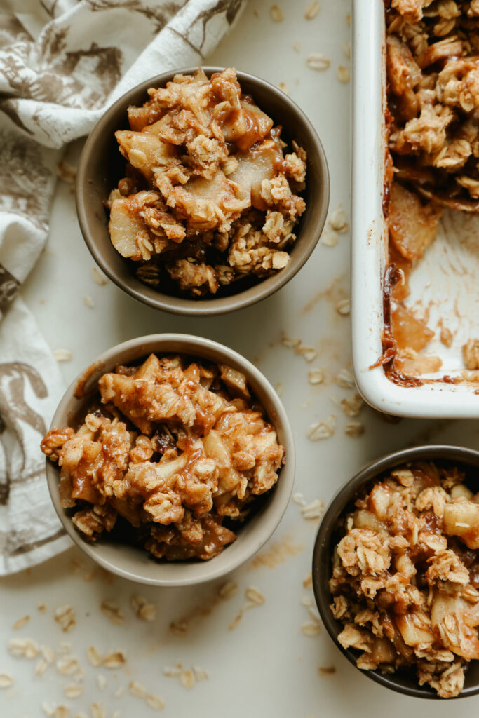 Healthy apple crisp with maple syrup served in small bowls