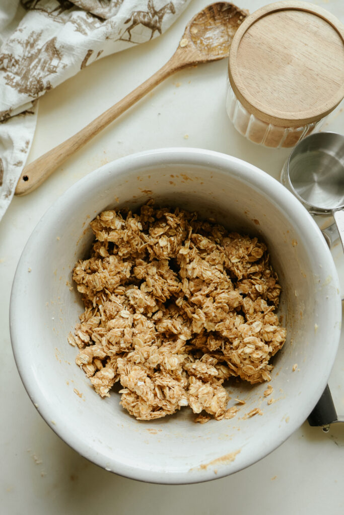 Crumbly maple oat topping mixed in a bowl for healthy apple crisp