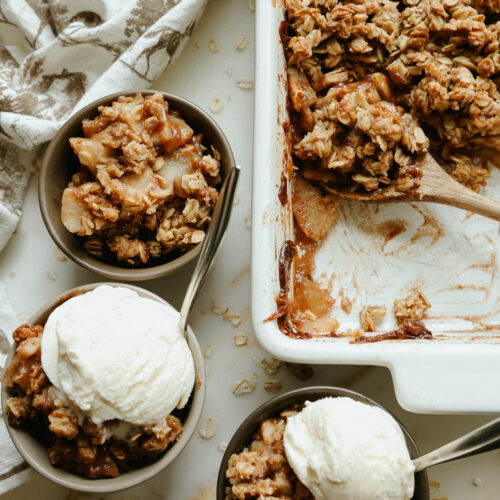 Healthy apple crisp with maple syrup topped with a scoop of vanilla ice cream