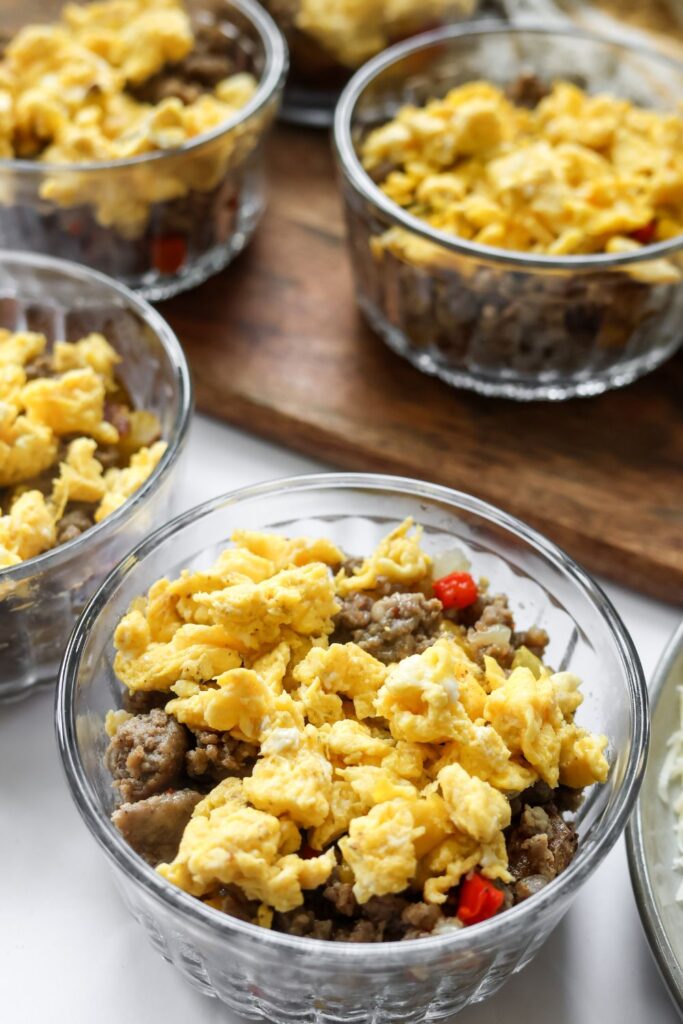 Hearty breakfast bowl with eggs, sausage, roasted potatoes, and peppers