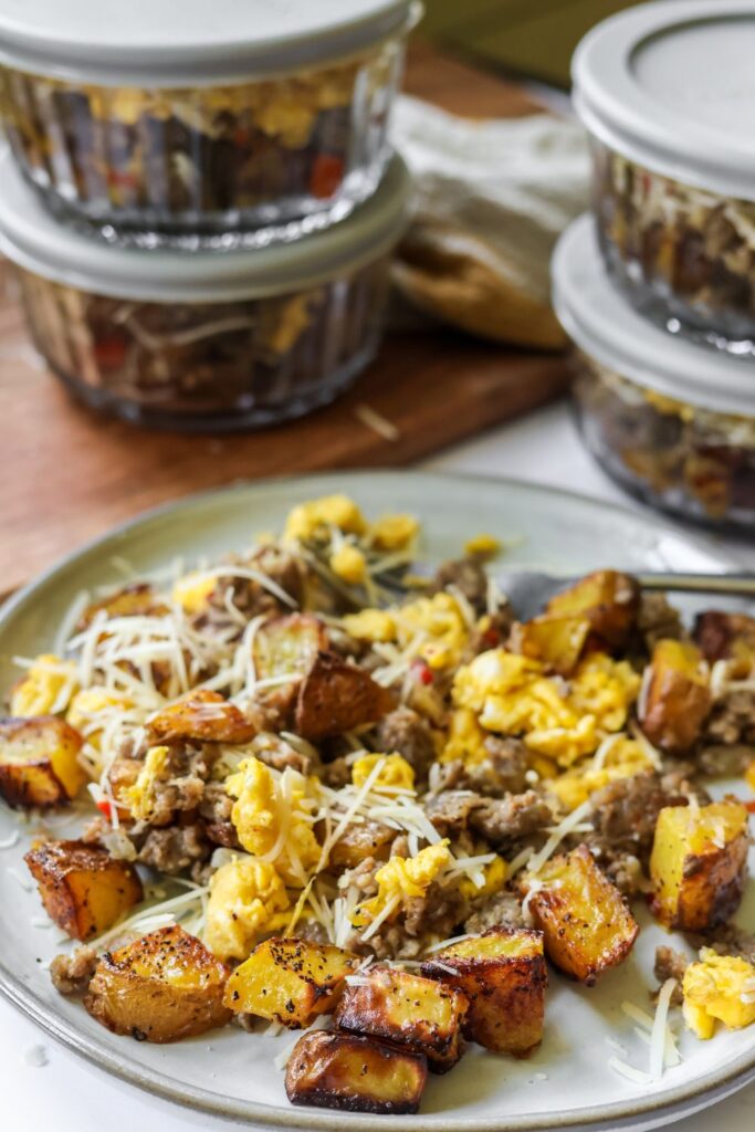 Easy breakfast bowl served warm with roasted potatoes, eggs, sausage, and freshly grated parmesan cheese