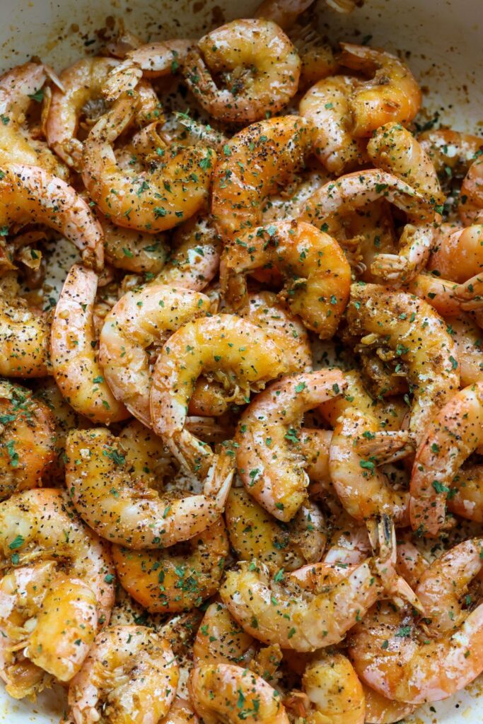 Buttery, golden brown shrimp tossed with Old Bay, black pepper, and fresh parsley—ready to peel and eat.