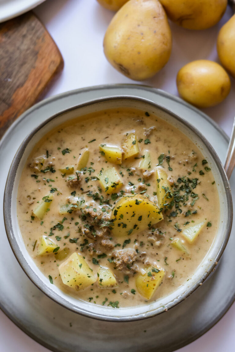 Family favorite cheesy hamburger potato soup with parsley and tender potatoes.