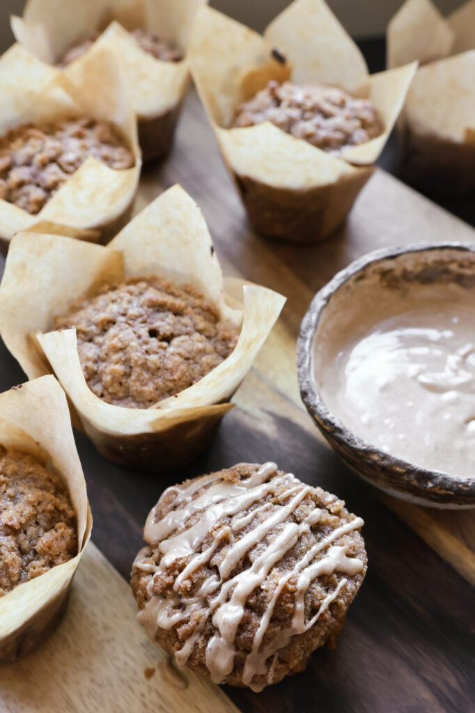 Homemade pumpkin muffins topped with brown sugar streusel and light glaze, ready to serve