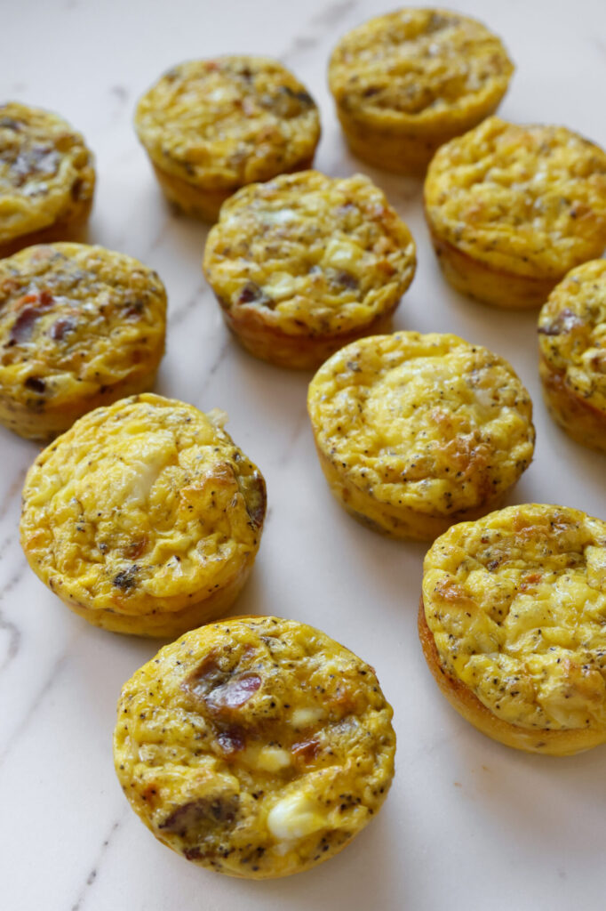 Homemade egg bites made with cottage cheese, bacon, cheddar, and red bell peppers