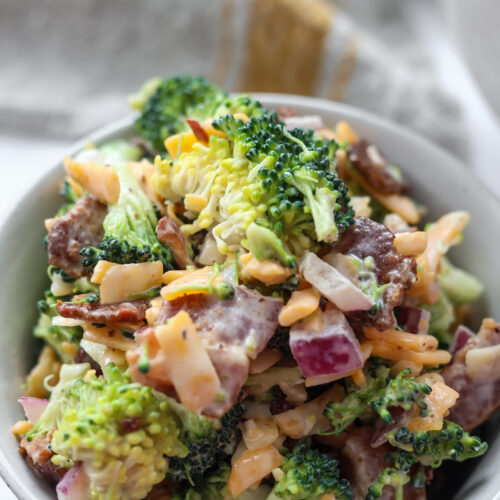 Easy broccoli salad recipe with crumbled bacon, shredded cheese, and creamy dressing.