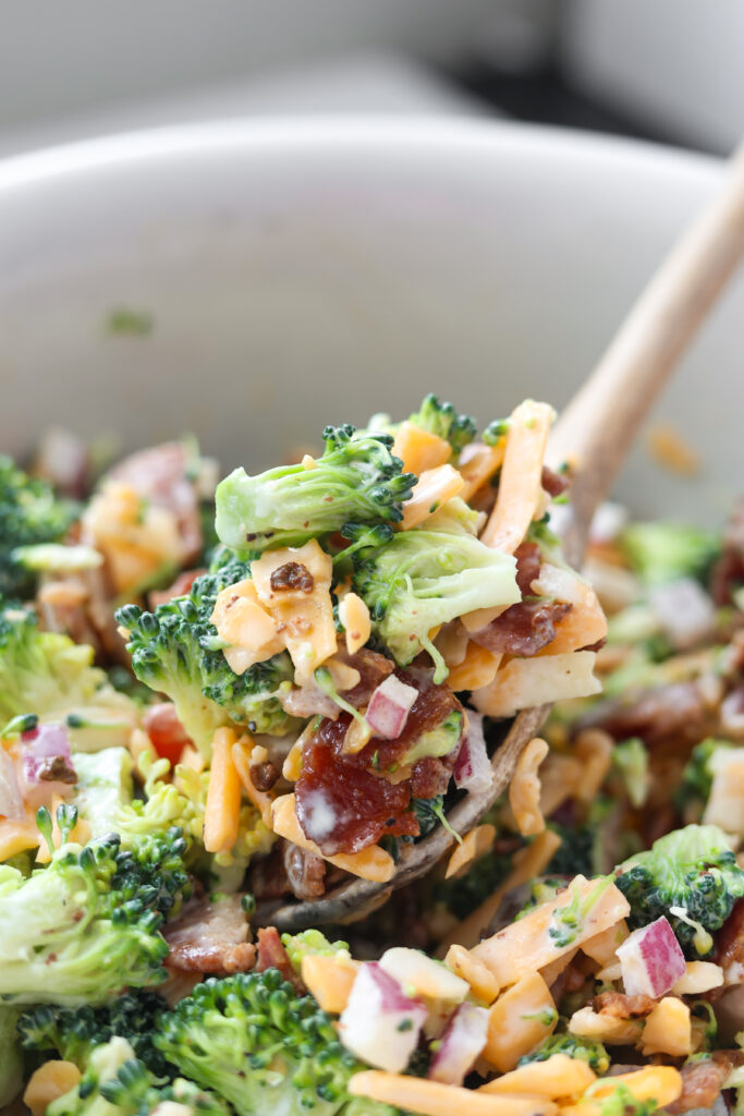 Classic broccoli salad with bacon, cheddar, and red onion ready to serve.