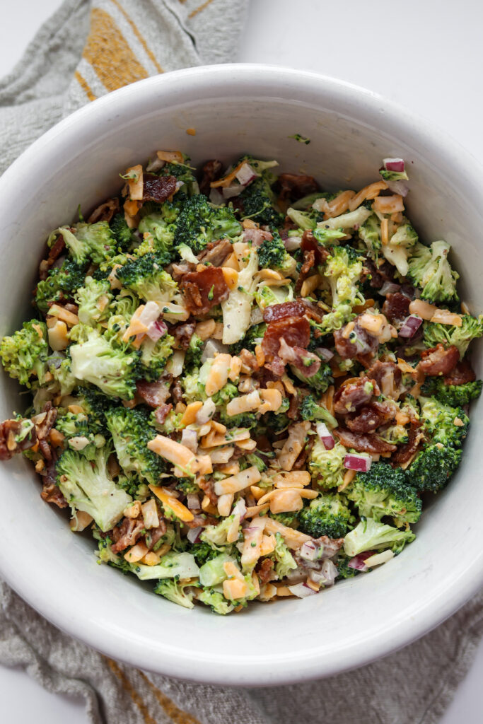 Broccoli salad with bacon and cheddar cheese in a large serving bowl