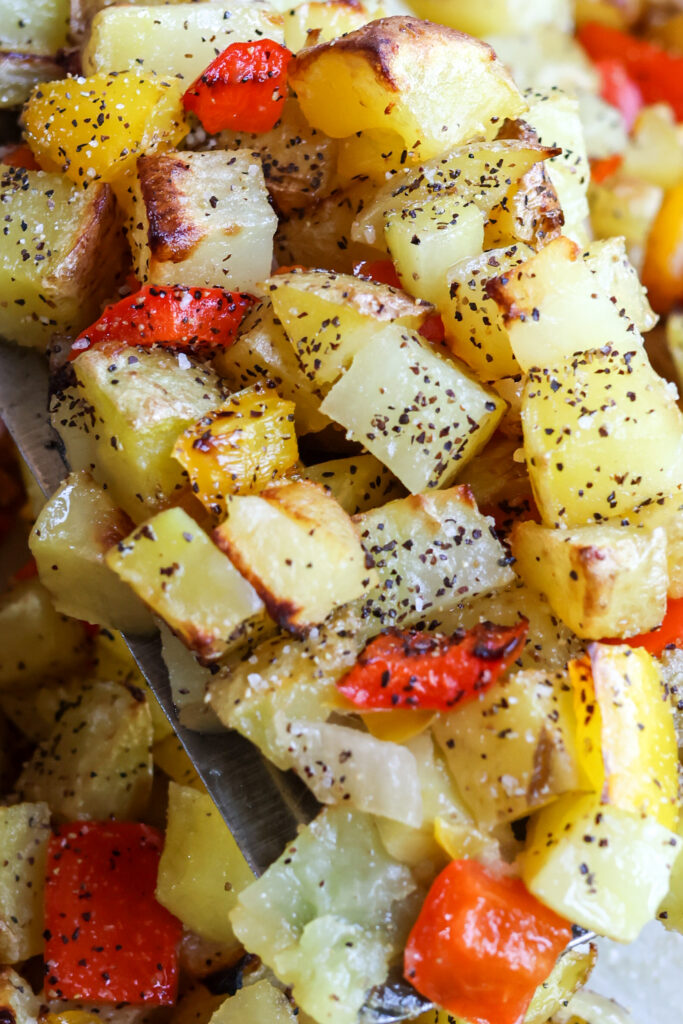 Golden crispy sheet pan breakfast potatoes with peppers from a baking sheet