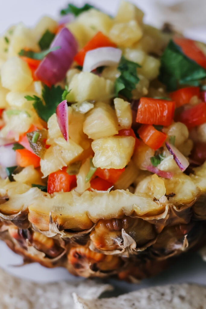 Close-up of fresh pineapple salsa with red bell pepper, red onion, and cilantro