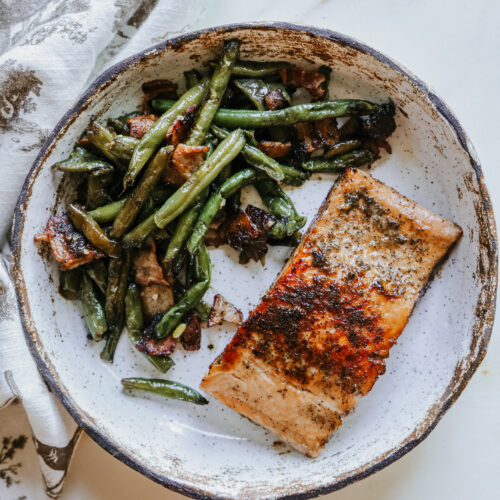 Plated brown sugar salmon recipe served with bacon green beans, top-down view